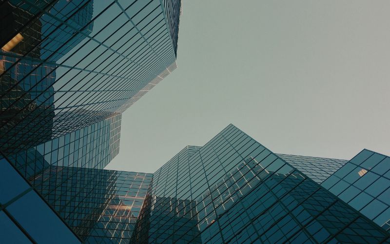 image is looking at 2 high-rise offices from below.